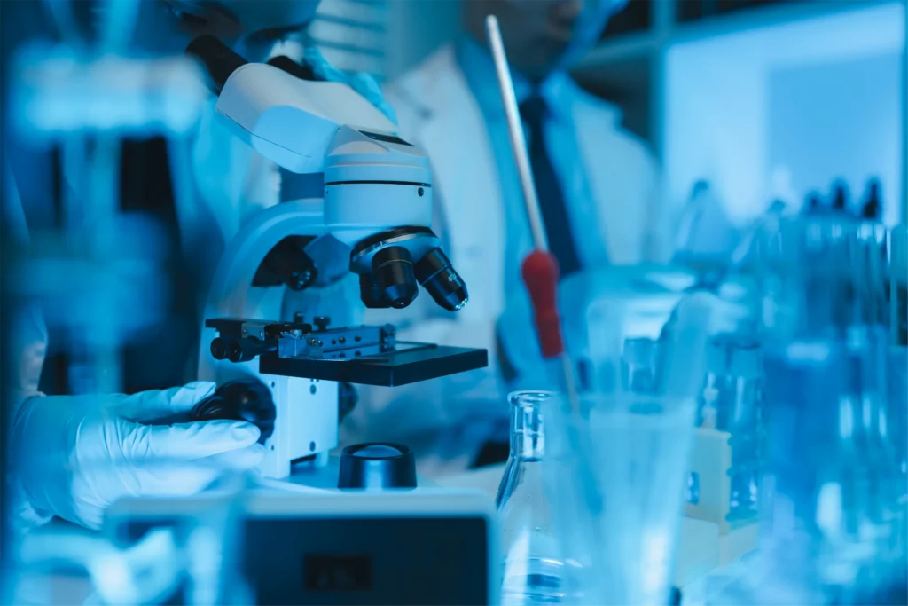 Laboratory researcher at a microscope